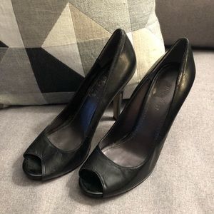 Black leather peep toe pumps